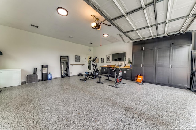 garage featuring a garage door opener and refrigerator