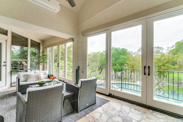 sunroom / solarium featuring ceiling fan, french doors, and lofted ceiling