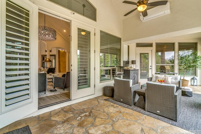 view of patio / terrace featuring ceiling fan, an outdoor living space, and an AC wall unit