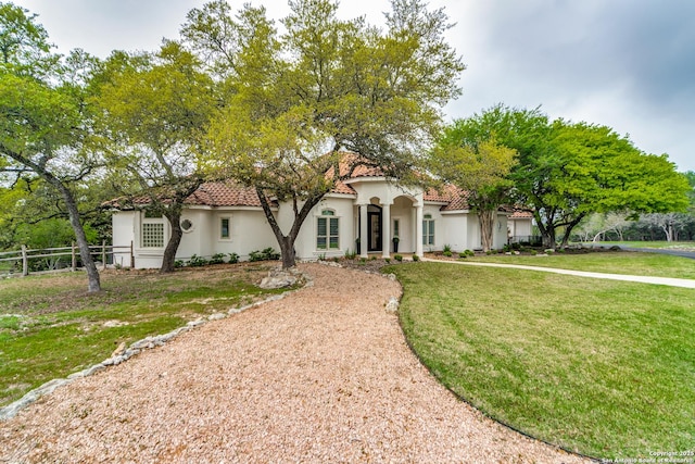 mediterranean / spanish home featuring a front yard