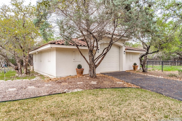 view of side of property with a yard and a garage