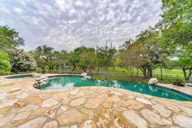 view of pool with a patio and an in ground hot tub