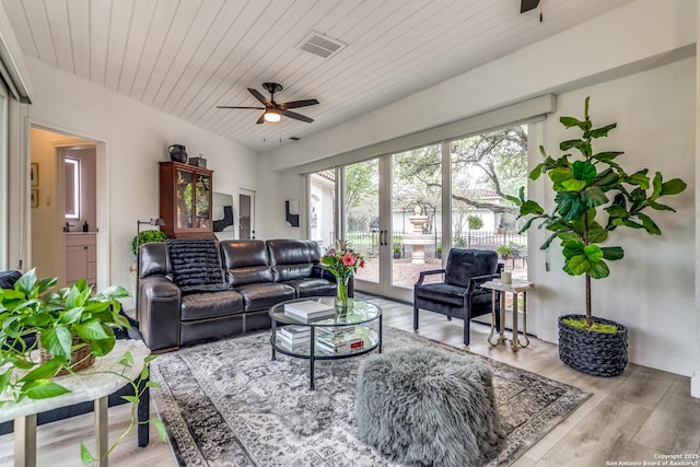 living room with light hardwood / wood-style floors, ceiling fan, french doors, and wooden ceiling