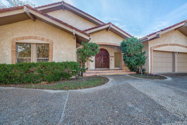 mediterranean / spanish house featuring a garage