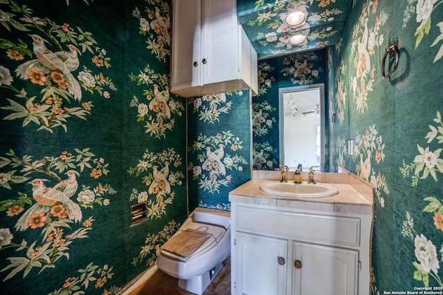 bathroom featuring vanity and toilet