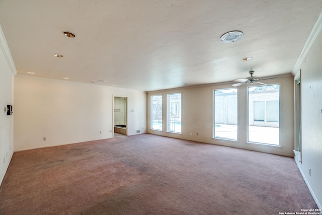 spare room with ornamental molding, ceiling fan, and light colored carpet