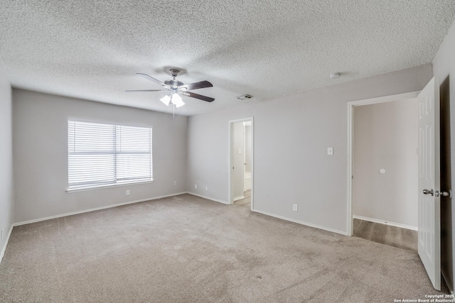 carpeted empty room with a textured ceiling and ceiling fan