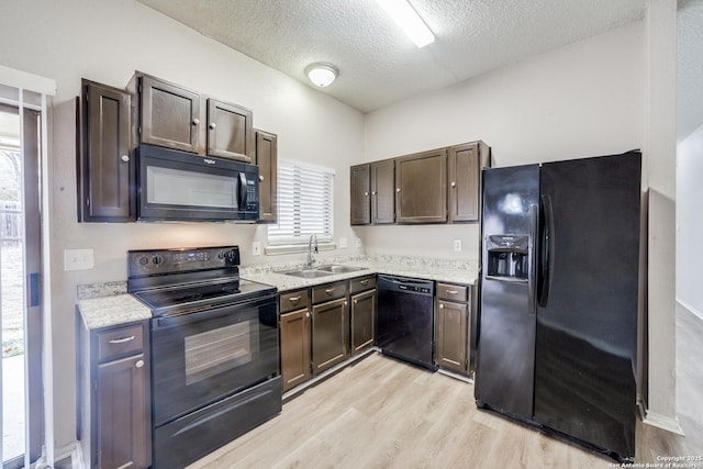 kitchen with black appliances, dark brown cabinets, a textured ceiling, and sink