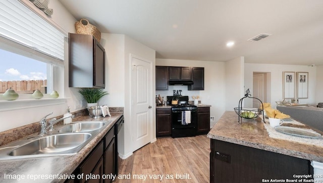 kitchen with dishwasher, light hardwood / wood-style flooring, black gas stove, dark brown cabinets, and sink