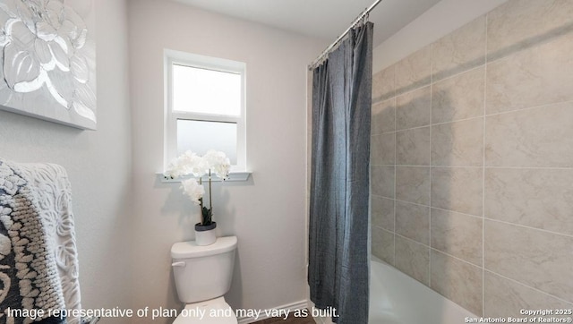 bathroom featuring shower / tub combo with curtain and toilet