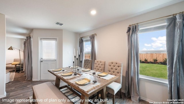 dining area with dark hardwood / wood-style flooring