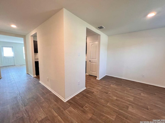 unfurnished room with dark hardwood / wood-style floors