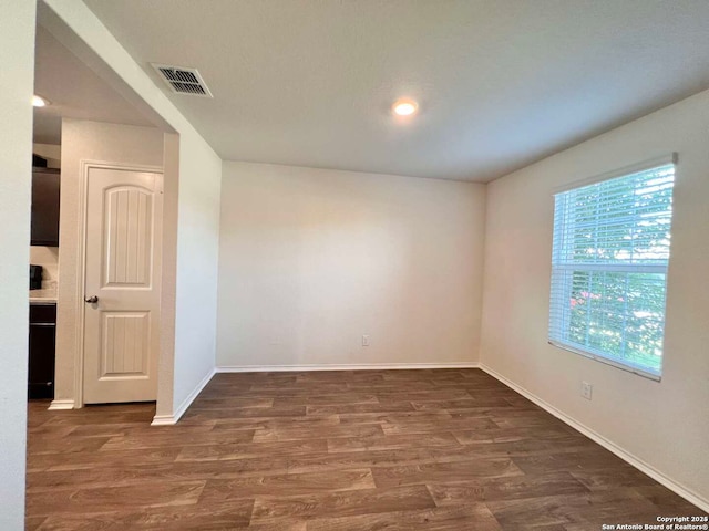 unfurnished room with dark hardwood / wood-style flooring