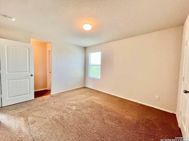 unfurnished bedroom featuring a textured ceiling and carpet flooring