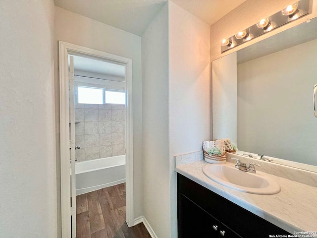 bathroom with a bathing tub, vanity, and wood-type flooring