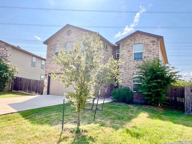 view of front of home with a front yard and a garage