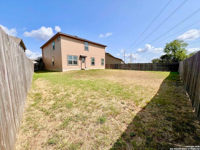 back of house featuring a lawn