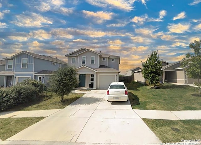 front of property with a garage and a lawn