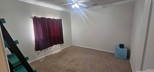 carpeted empty room featuring ornamental molding and ceiling fan