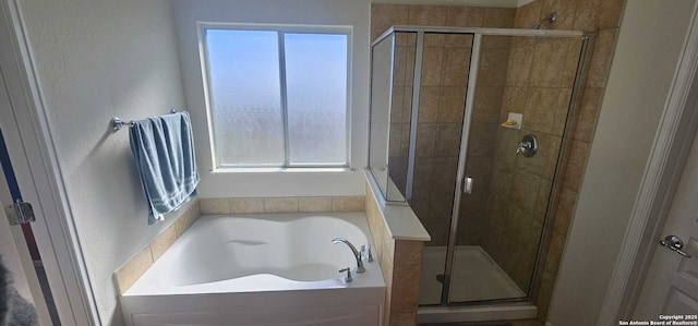 bathroom featuring separate shower and tub