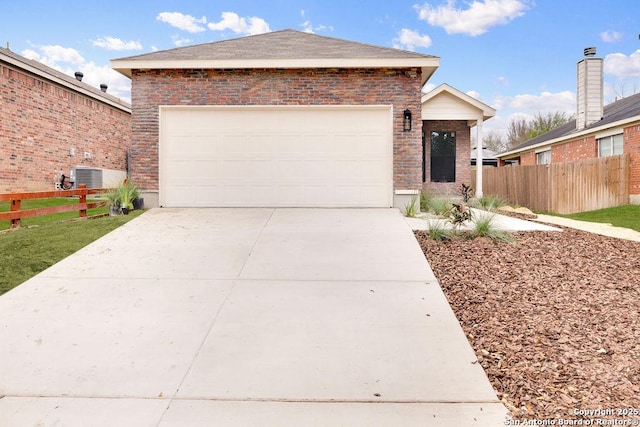 view of front of house featuring central AC unit and a garage