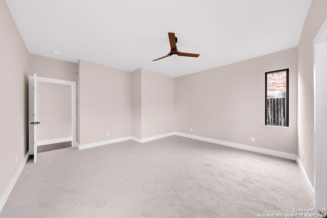 spare room featuring ceiling fan and light carpet