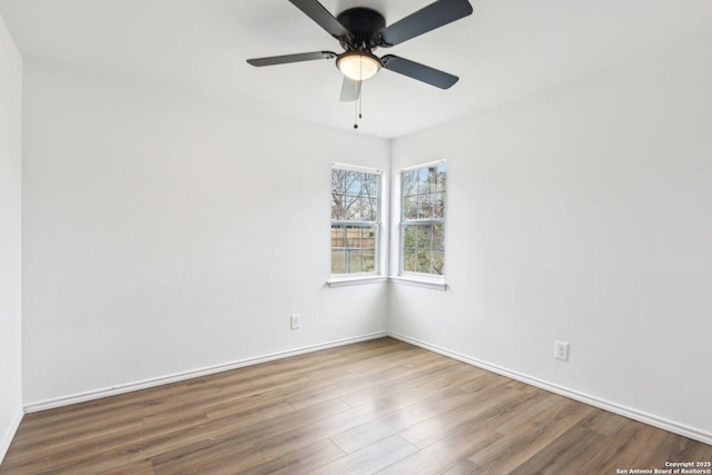 unfurnished room with ceiling fan and wood-type flooring