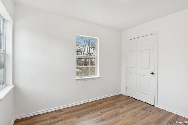 empty room with hardwood / wood-style floors