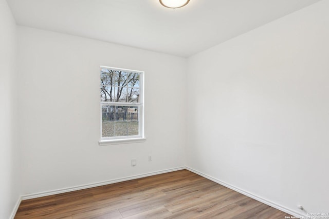 empty room with light wood-type flooring and a wealth of natural light