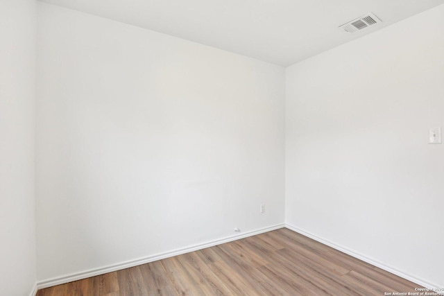 unfurnished room with hardwood / wood-style flooring