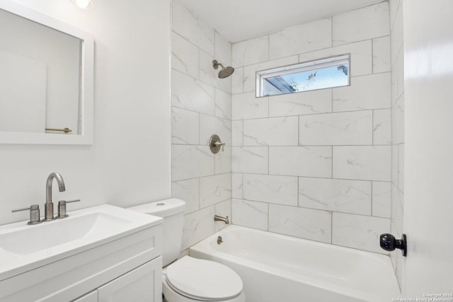 full bathroom with toilet, vanity, and tiled shower / bath