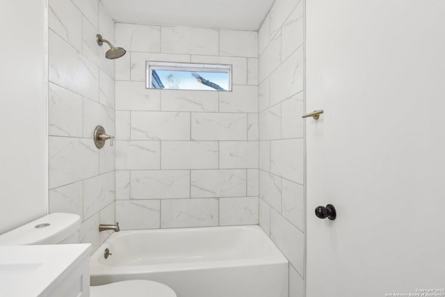 full bathroom with toilet, vanity, and tiled shower / bath