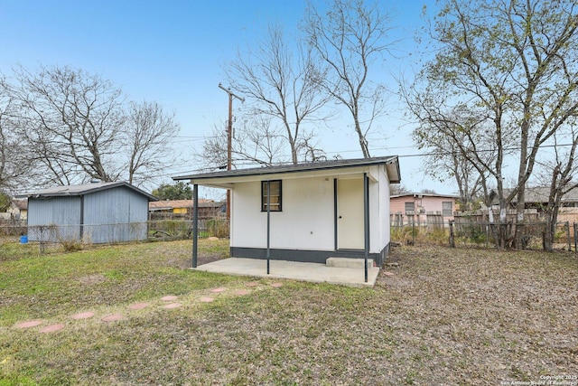 view of outbuilding featuring a lawn