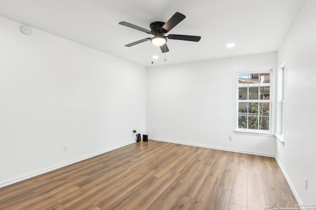 unfurnished room with hardwood / wood-style flooring and ceiling fan