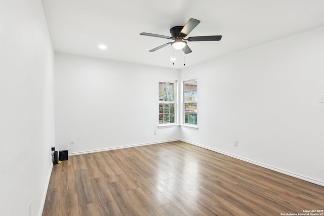 empty room featuring hardwood / wood-style flooring and ceiling fan