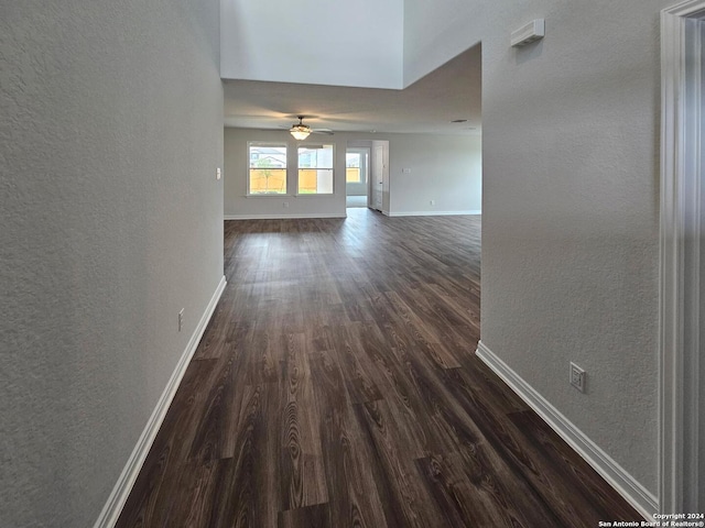 hallway with dark hardwood / wood-style flooring