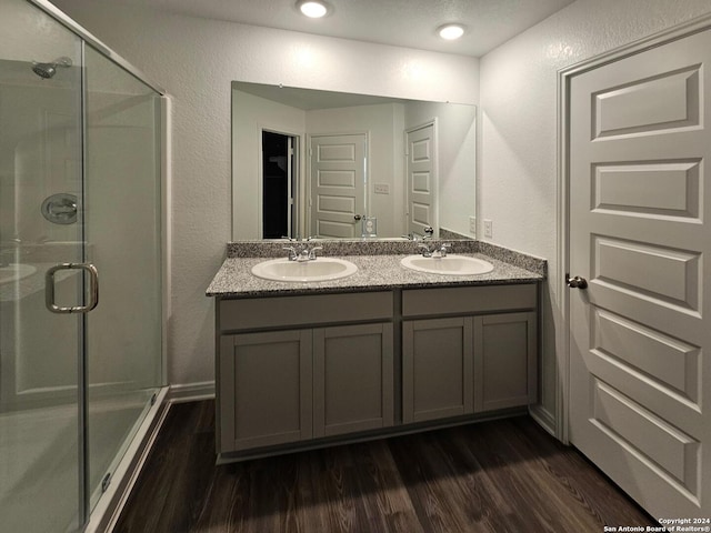 bathroom featuring an enclosed shower, vanity, and hardwood / wood-style floors