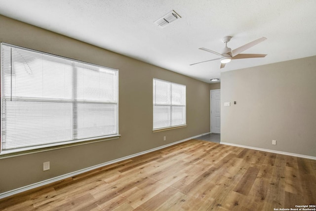 unfurnished room featuring ceiling fan and light hardwood / wood-style flooring