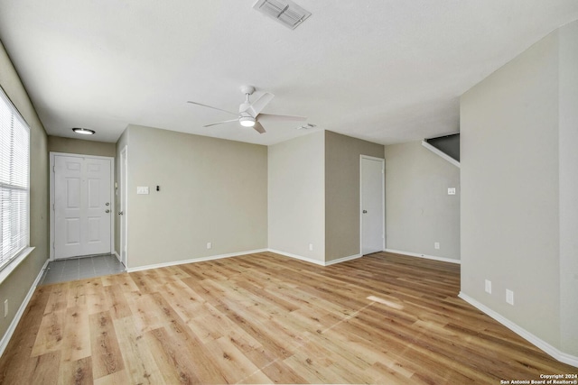 spare room with ceiling fan and light hardwood / wood-style flooring