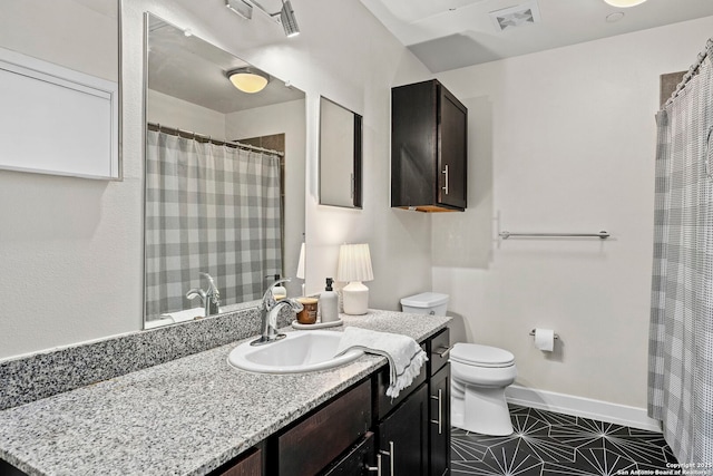 bathroom featuring vanity, toilet, and tile patterned flooring