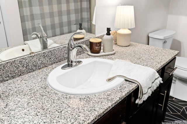 bathroom featuring toilet and vanity