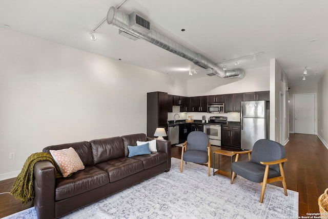 living room with light hardwood / wood-style floors and sink