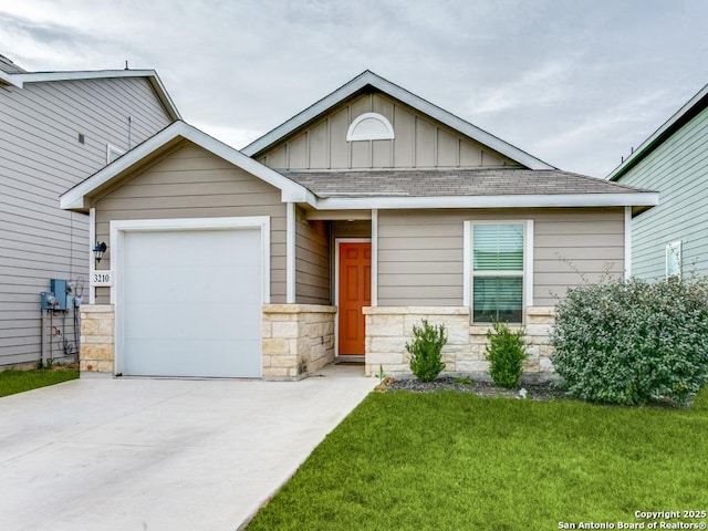 view of front of house with a front yard and a garage