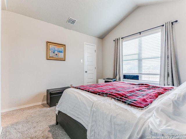 bedroom featuring lofted ceiling and carpet floors