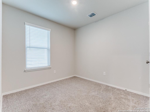 unfurnished room with light carpet