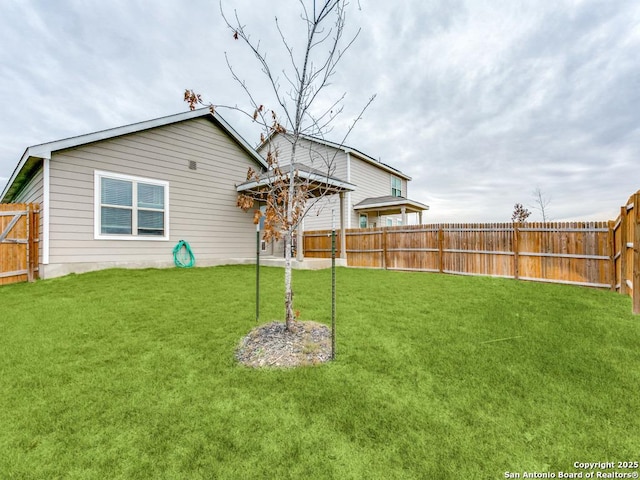 rear view of property featuring a lawn