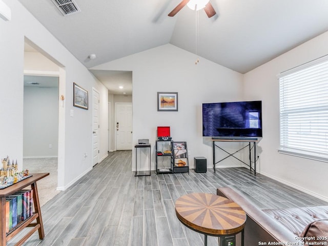 interior space with lofted ceiling, ceiling fan, and hardwood / wood-style floors