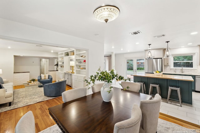 dining area featuring sink and light hardwood / wood-style floors