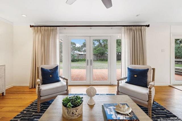 living room featuring hardwood / wood-style flooring, ornamental molding, and french doors