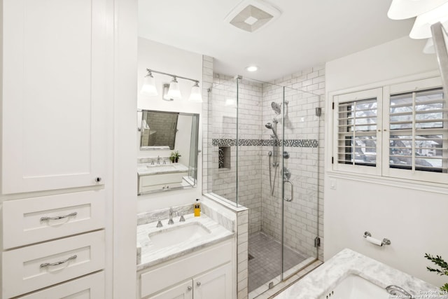 bathroom featuring an enclosed shower and vanity